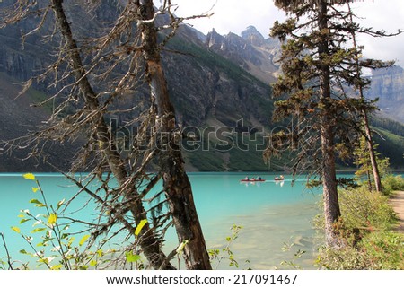 LAKE LOUISE, ALBERTA, CANADA - AUGUST 27, 2014: People canoeing on Lake Louise in Banff National Park, Alberta, Canada
