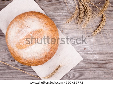 Fresh bread on wooden ground