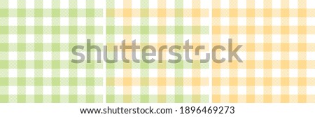 Gingham patterns in pastel green and yellow. Spring textured light bright tartan vichy check plaid graphic background vector for dress, skirt, shirt, tablecloth, or other modern fashion fabric design.