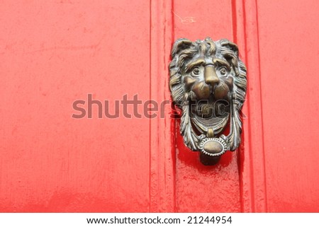 Lion Door Knocker on a Red Painted Door