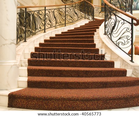 a grand internal carpeted staircase winding around