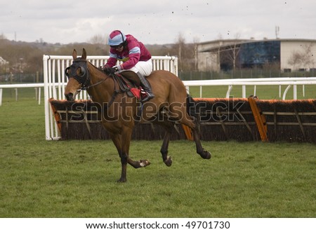 NEWBURY, BERKS - MAR 27: Jockey Paul Moloney takes extreme impact over hurdles in the first race at Newbury Racecourse, UK, March 27, 2010 in Newbury, Berks