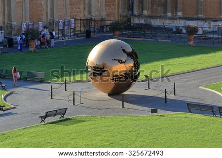 Vatican - August 18, 2015: People near modern installation Sphere within Sphere by Arnaldo Pomodoro in Belvedere Courtyard