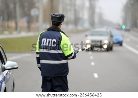 the police officer stops the car