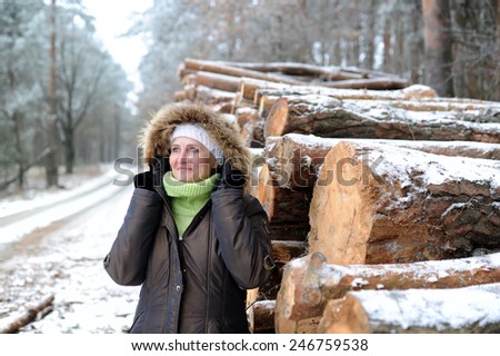 the woman costs close to a warehouse of logs