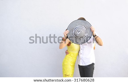 the guy and the girl hid the faces for round striped a sombrero