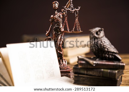 Golden scales of justice, books, Statue of Lady Justice. Owl