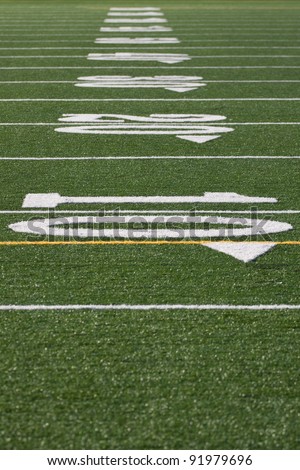 Closeup of yard lines from scrimmage line on football, soccer field