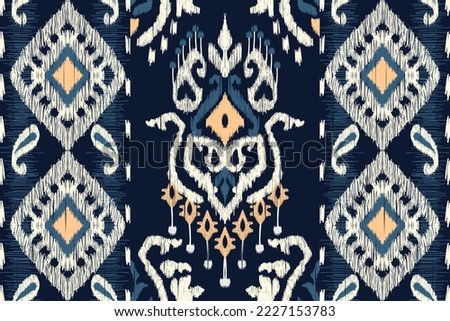 African Ikat paisley embroidery on navy blue background.geometric ethnic oriental seamless pattern traditional.Aztec style abstract vector illustration.design for texture,fabric,clothing,wrapping.
