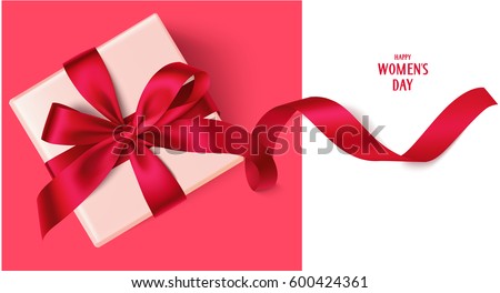 Decorative gift box with red bow and long ribbon. Happy Women's Day text. Top view