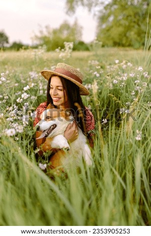 Similar – Image, Stock Photo Caucasian woman holding puppy. Adopted border collie dog held by a caucasian woman with long blond hair. Friendship and family.