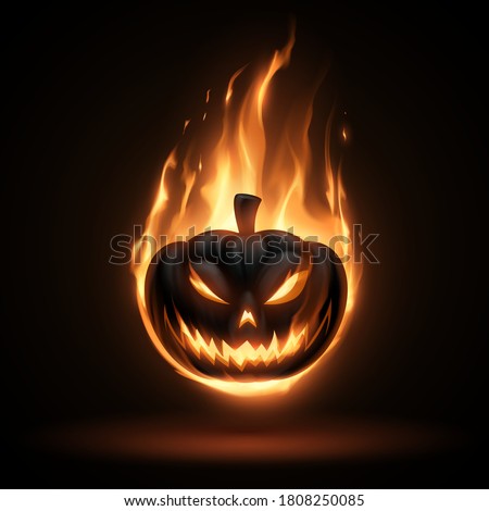 Black halloween pumpkin in fire