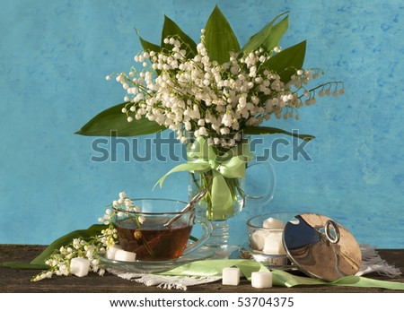 with lilies and a cup of tea and spring white and pink flowers