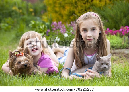 little girls and  cat and dog