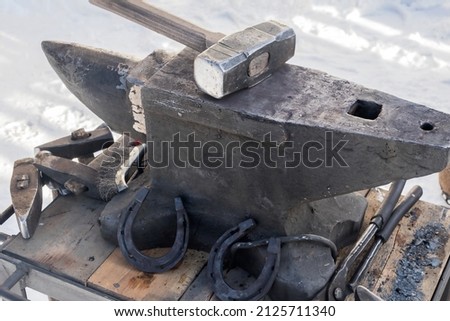 Similar – Image, Stock Photo Blacksmith forging horseshoe near stable