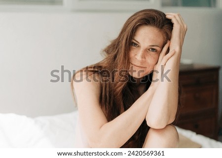 Similar – Image, Stock Photo Confident pensive freckled woman smoking on bed