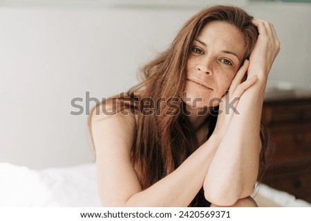 Similar – Image, Stock Photo Confident pensive freckled woman smoking on bed