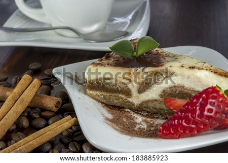 italian desert tiramisu with coffe and strawberry on wood table