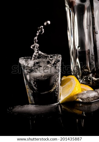 Tequila with lemon or lime and salt on reflex background