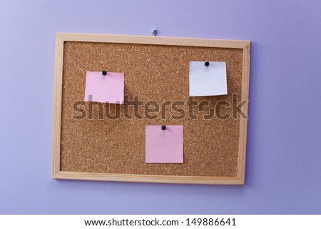 Notice board with empty stickers on a purple wall