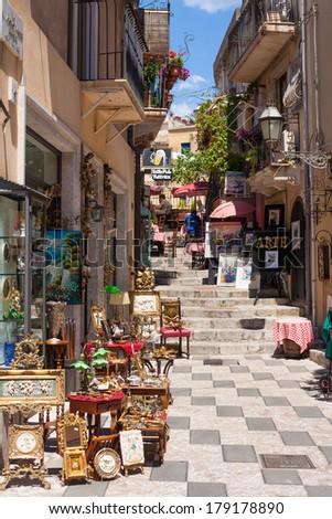 TAORMINA, ITALY - MAY 11, 2012: A street in Taormina with a restaurant and a bazaar in Sicily, Italy