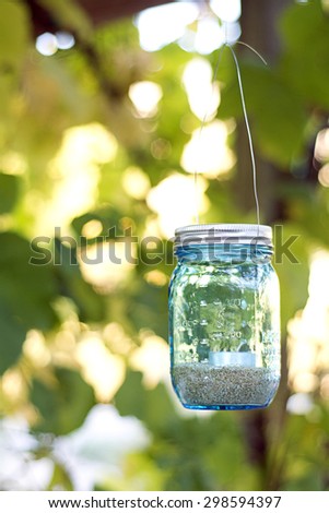blue mason jar candle hanging for decoration at a party or wedding