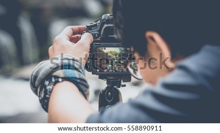 Similar – Image, Stock Photo Male photographer taking picture with camera on street