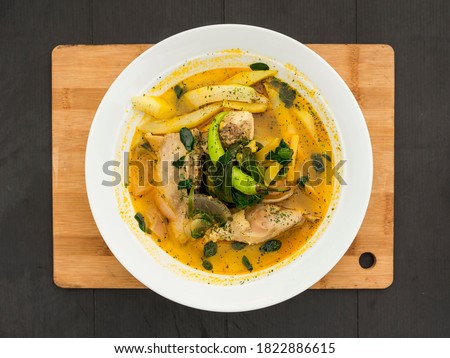 Top view of a large serving of Chicken Tinola, a Filipino soup dish served as an appetizer or a main entrée with white rice. Сток-фото © 