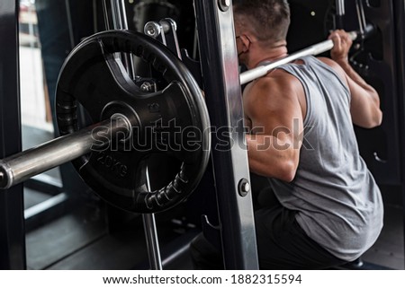 A warm up set of squats at a smith machine. Focus on barbell plate. ストックフォト © 