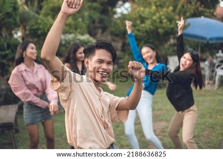 Five friends having fun partying at the garden. Focus on the sole male with four women behind. Foto stock © 