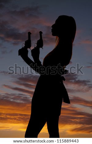 A silhouette of a woman blowing off the tip of her gun.