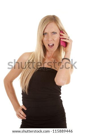 a woman talking on the phone with a mad expression on her face.