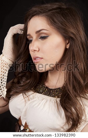 a close up of a woman\'s face in her western vintage dress and gloves.