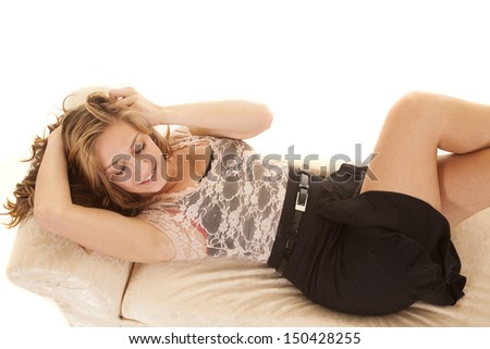 A business woman is laying on a bench top view.