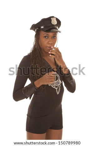 A woman cop standing with a pair of handcuffs.