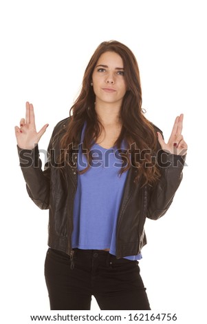A woman is holding up her hands pretending they are guns.