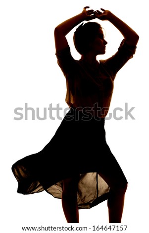 a silhouette of a woman dancing in her sheer dress.