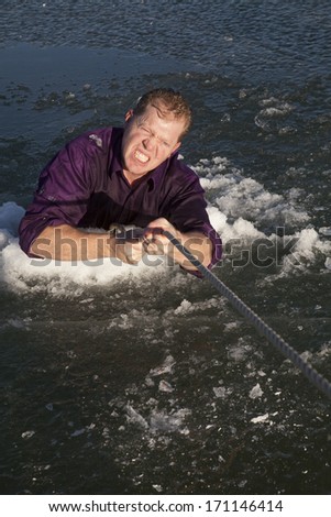 a man gritting his teeth and getting pulled out by a rope.