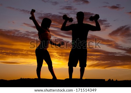 a silhouette of a man and woman working out with weights.
