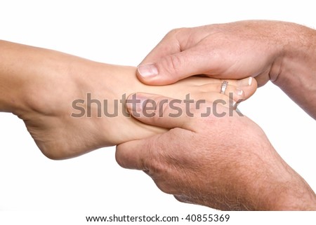 A woman's foot getting a well deserved foot massage.