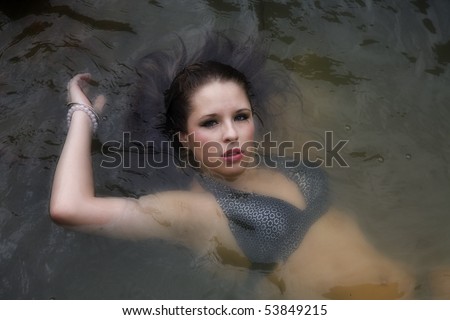 A close up of a woman floating in the water.