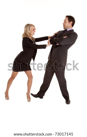A business man and woman fighting and pushing the business man out of her way.