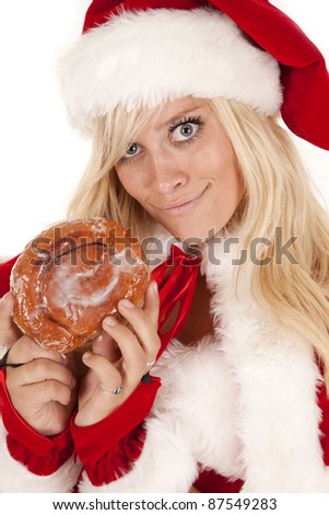 Mrs Santa caught with a big doughnut she has a smirk on her face.