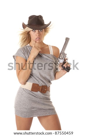 A woman in her gray short dress with  a western hat and holding a pistol with  a shocked expression.