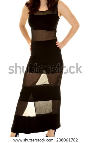 A woman in her black and sheer dress with her hands on her hips.