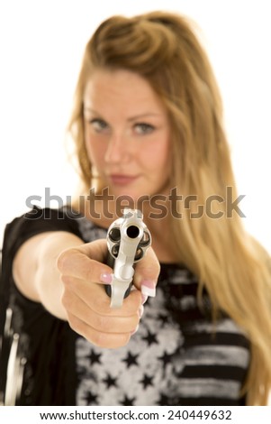 A close up of a woman holding onto a gun, pointing it at the camera.