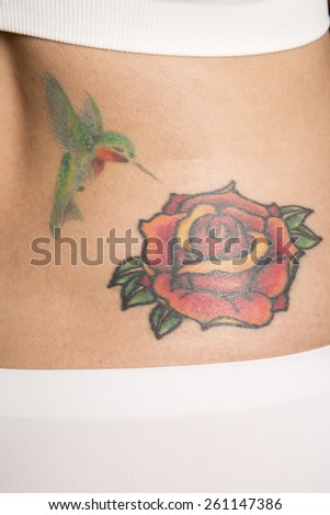 A close up of a woman\'s tattoo on her back.
