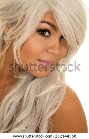 A woman looking over to the side of her shoulder, with silver hair .