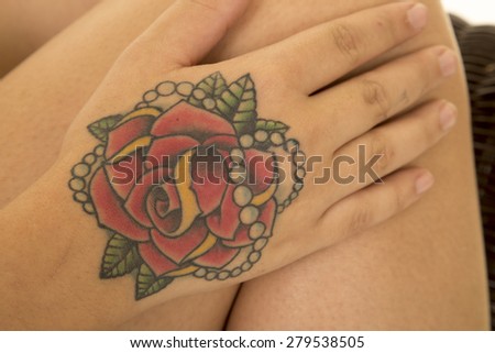 A tattoo on a woman\'s hand up close.