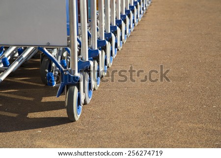 Row of luggage carts with advertisement space closeup view